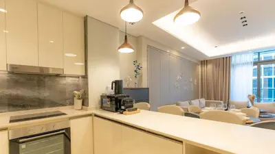 a kitchen with a counter and chairs in a room at The Nobles Tower High Floor with Elegant City View in Dubai
