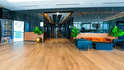 a lobby of a building with a couch and tables at The Nobles Tower High Floor with Elegant City View in Dubai
