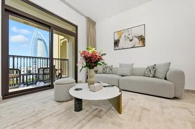 a living room with a couch and a table with flowers at Lamtara in Dubai