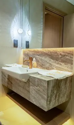a bathroom with a sink and a wooden wall at Brand New 1BR Apartment in JVC in Dubai