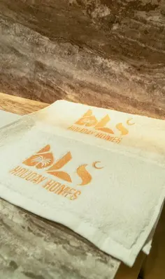 a napkin sitting on top of a wooden table at Brand New 1BR Apartment in JVC in Dubai