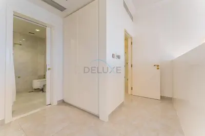 a white hallway with a toilet in a bathroom at Panoramic Sea and Canal Views from High-Floor 2BR, Steps from Tram and Marina Beach, Shams 2, JBR by Dekuxe Holiday Homes in Dubai