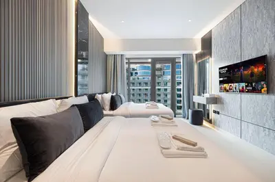 a living room with a large bed and a tv at Restay Homes at Seven Palm Hotel & Apartments - Pool and Beach Access included in Dubai