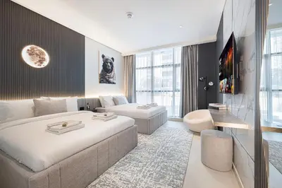 a living room with a large bed and a couch at Restay Homes at Seven Palm Hotel & Apartments - Pool and Beach Access included in Dubai