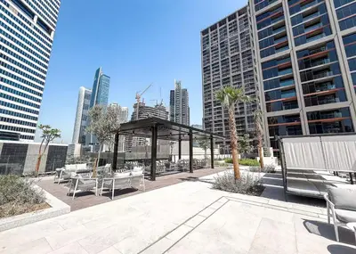 a pavilion with tables and benches in a city at Brand New 2BR Peninsula One with Burj Khalifa View in Dubai