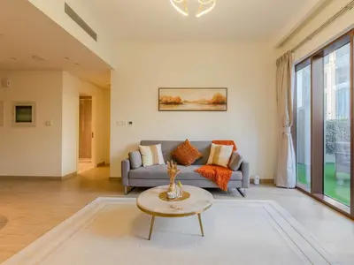a living room with a couch and a table at Luxury Dubai Creek Beach with Private Lagoon in Dubai