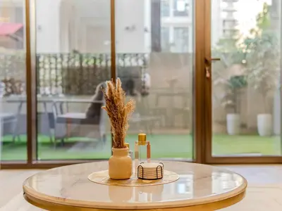a round table with a vase with dried flowers on it at Luxury Dubai Creek Beach with Private Lagoon in Dubai