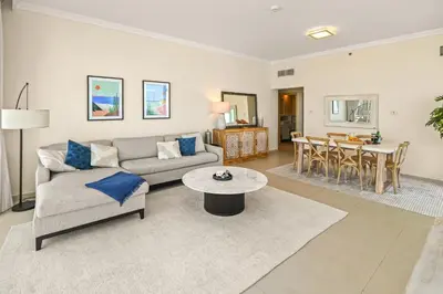 a living room with a couch and a table at 1st Row Beach Views with Private Beach and Resort Vibes in Dubai