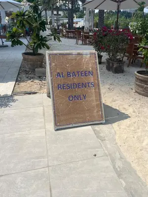 a sign that says all kitchen residents only on a sidewalk at 1st Row Beach Views with Private Beach and Resort Vibes in Dubai