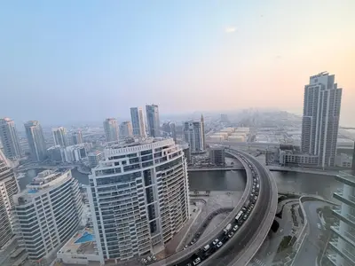 an aerial view of a city with buildings and a freeway at Beachfront Luxury Penthouse at The Walk JBR next to Bluewaters Island - 2BR & Maids Room in Dubai