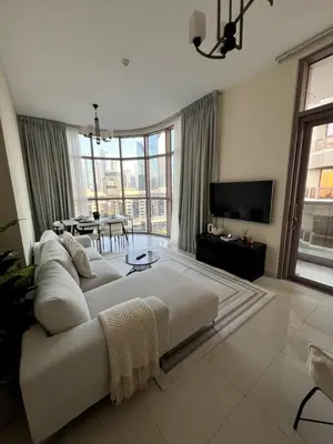 a large living room with a white couch and a table at Amazing 1BR Full Burj View in Dubai