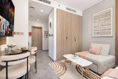 a living room with a couch and a table at Canal Walk Luxury Studio Central Business Bay in Dubai
