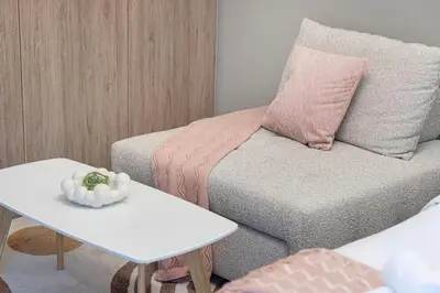 a living room with a couch and a table at Canal Walk Luxury Studio Central Business Bay in Dubai