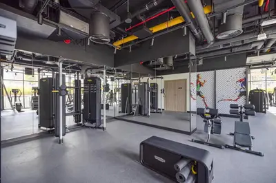 a gym with a lot of equipment in a room at Canal Walk Luxury Studio Central Business Bay in Dubai
