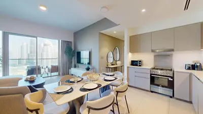 a kitchen and dining room with a table and chairs at Vacationer l Fountain, Burj Khalifa View l 2 Bedroom l Downtown Dubai in Dubai