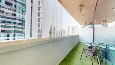 a balcony with tables and chairs in a building at Vacationer l Stylish 1 Bedroom l Downtown Dubai l Pool, Gym Access in Dubai
