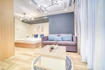 a living room with a couch and a bed at Vacationer I Upgraded Studio I Heart of JBR I Near JBR Beach, Cafes & Restaurants in Dubai