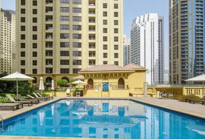 a large swimming pool in a city with tall buildings at Vacationer I Upgraded Studio I Heart of JBR I Near JBR Beach, Cafes & Restaurants in Dubai