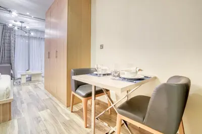 a dining room with a white table and chairs at Vacationer I Upgraded Studio I Heart of JBR I Near JBR Beach, Cafes & Restaurants in Dubai