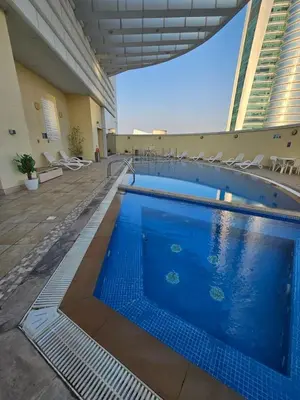 a large swimming pool with chairs in a building at JLT Studio, Steps to Metro, High floor, Smart Home in Dubai