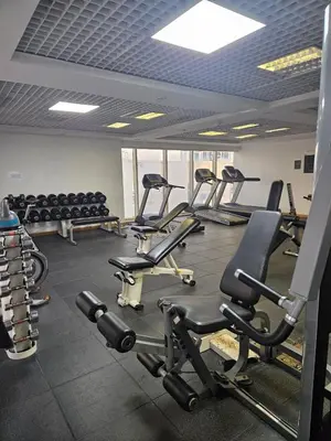 a gym with several rows of exercise bikes and weights at JLT Studio, Steps to Metro, High floor, Smart Home in Dubai