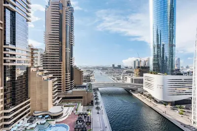 a view of a river in a city with tall buildings at Exquisite Marina Home with Panoramic Yacht Views in Dubai