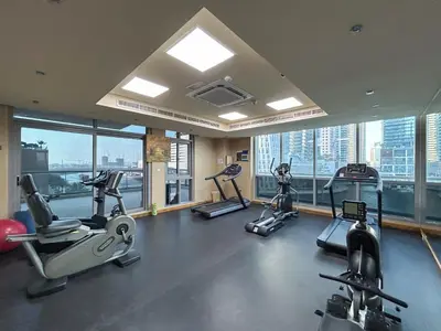 a gym with treadmills and ellipticals in a building at Exquisite Marina Home with Panoramic Yacht Views in Dubai