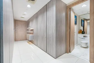 a bathroom with wooden walls and a toilet at Exquisite Marina Home with Panoramic Yacht Views in Dubai
