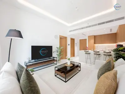 a living room with a couch and a table at Modern Retreat at Azizi Azure, Meydan in Dubai