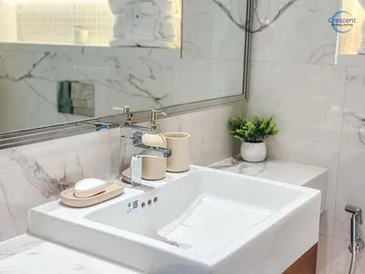 a white bathroom with a sink and a mirror at Modern Retreat at Azizi Azure, Meydan in Dubai