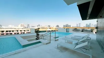 a swimming pool on the roof of a building at Elegant 1BR Stay in Binghatti Heights JVC in Dubai