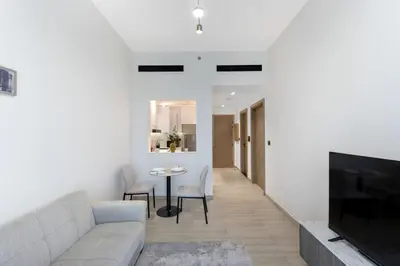 a living room with a couch and a table at Elegant 1BR Stay in Binghatti Heights JVC in Dubai