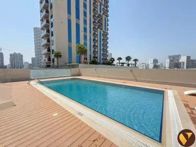 a swimming pool on the roof of a building at Vogue JVC Jeewar Tower near Circle Mall, Two Bedroom Apartment with Balcony and City View, Access to all Amenities in Dubai