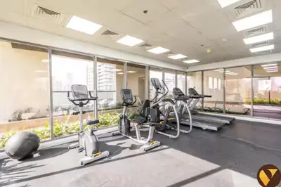 a gym with treadmills and elliptical machines at Vogue JVC Jeewar Tower near Circle Mall, Two Bedroom Apartment with Balcony and City View, Access to all Amenities in Dubai