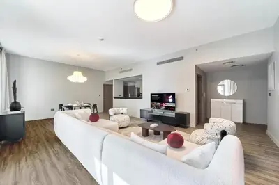 a living room with a large white couch and chairs at FAM Living - 1 Bedroom in Rimal 2 Dubai Marina in Dubai