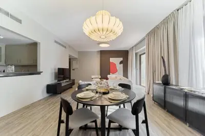 a living room with a table and chairs and a couch at FAM Living - 1 Bedroom in Rimal 2 Dubai Marina in Dubai