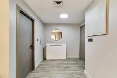 a hallway with a door and a mirror at FAM Living - 1 Bedroom in Rimal 2 Dubai Marina in Dubai