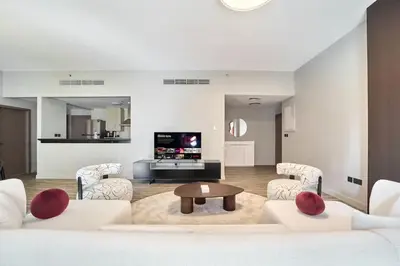 a living room with white furniture and a table at FAM Living - 1 Bedroom in Rimal 2 Dubai Marina in Dubai