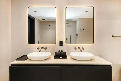 two sinks in a bathroom with two mirrors at Opera Grand Sky Luxurious 3-Bedroom Apartment in Downtown Dubai with Panoramic Burj Khalifa View in Dubai