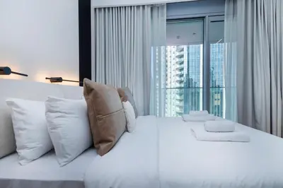 a bedroom with a white bed with a large window at Opera Grand Sky Luxurious 3-Bedroom Apartment in Downtown Dubai with Panoramic Burj Khalifa View in Dubai