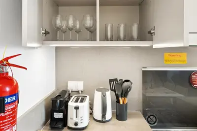 a kitchen counter with cups and utensils on it at Creek Beach Sunset 3! Lagoon Access! in Dubai