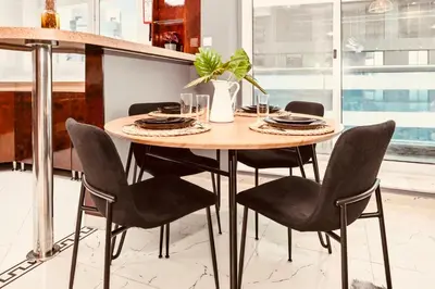 a table in a kitchen with chairs around it at Luxury Retreat Your High Floor Heaven in Marina in Dubai
