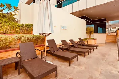 a waiting area with chairs and an umbrella at Luxury Retreat Your High Floor Heaven in Marina in Dubai