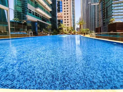 a large swimming pool in a city with tall buildings at Lavish Marina Gem - Dubai Eye Views - Infinity Pool in Dubai