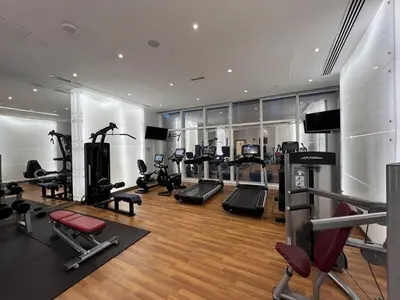a gym with several treadmills and cardio machines at Lavish Marina Gem - Dubai Eye Views - Infinity Pool in Dubai