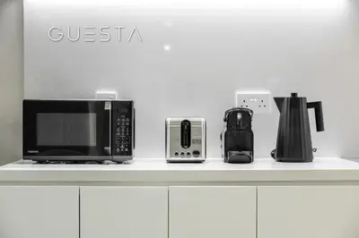 a counter with a microwave and other appliances on it at La Cote by Merass, La Mer Dubai in Dubai