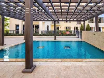 a swimming pool under a pergola with a swimming pool at La Cote by Merass, La Mer Dubai in Dubai
