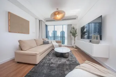 a living room with a couch and a table at StayShort - Sophisticated unit in JLT Sleeps 6 with Lake Views in Dubai