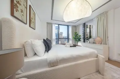 a white bedroom with a large bed with a window at StayShort - Sophisticated unit in JLT Sleeps 6 with Lake Views in Dubai