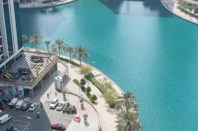an aerial view of a large body of water with palm trees at StayShort - Sophisticated unit in JLT Sleeps 6 with Lake Views in Dubai